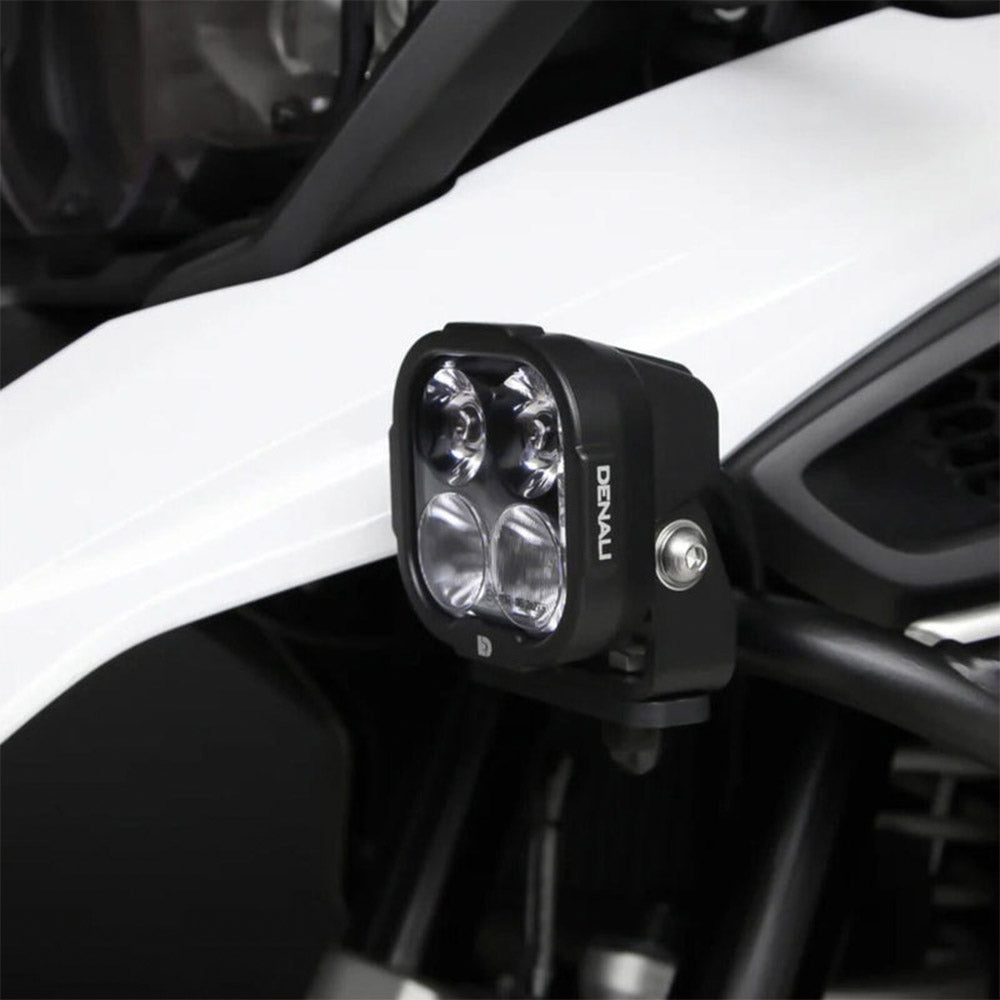 Black driving light pod close-up with clear multi-lens housing and mounting bolt