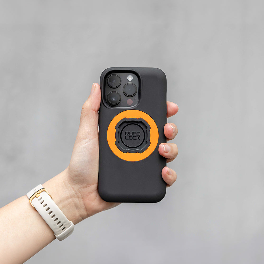 Black phone case with orange circular ring lock attachment on the back