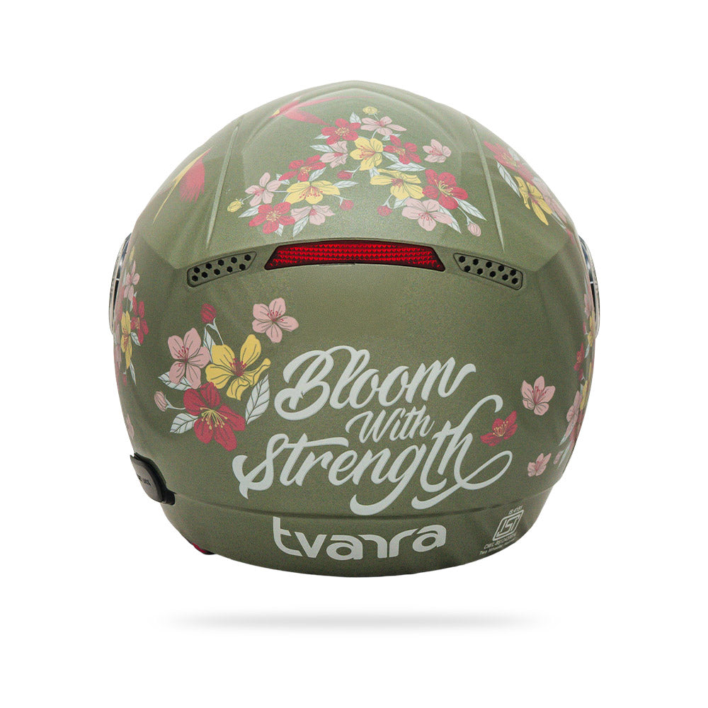 Jade green motorcycle helmet with “Bloom with Strength” floral artwork and logo