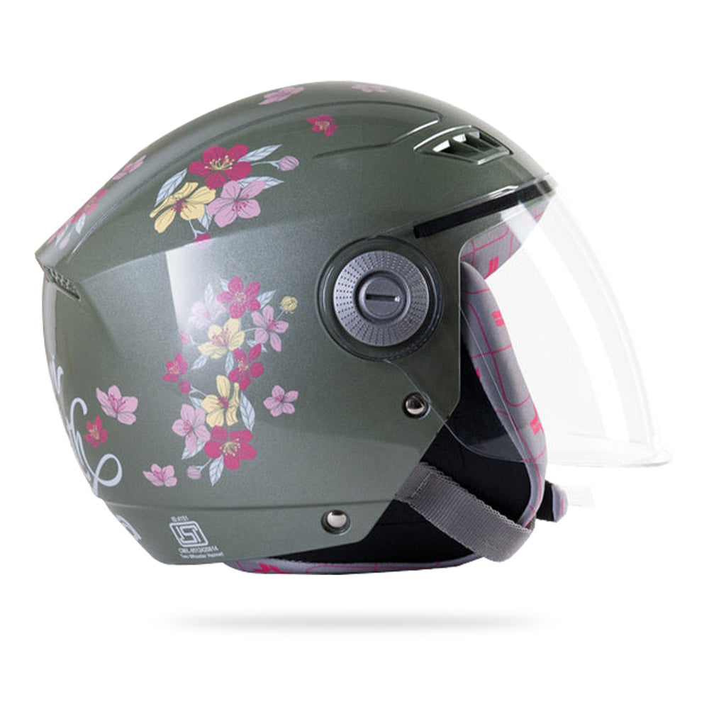 Jade green women’s motorcycle helmet with clear face shield and circular control detail