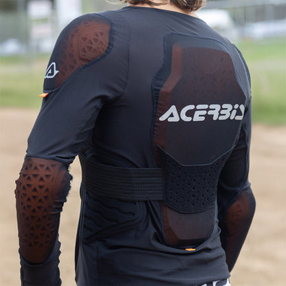 Black armored jacket worn, showing back ACERBIS logo, orange-brown shoulder inserts.