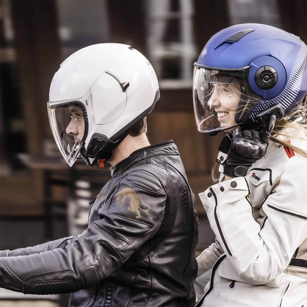 Black CARDO Spirit HD helmet headset on rider with clear visor
