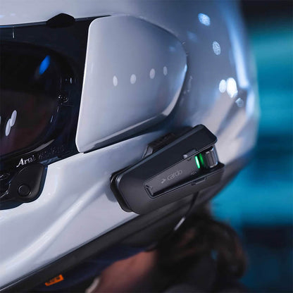 Black intercom unit mounted on helmet side with green status LED