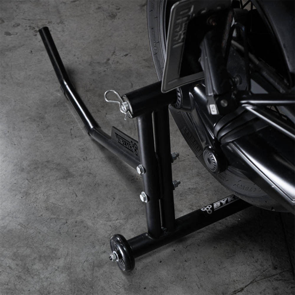 Black paddock stand base frame with mounting bolts and side lifting arm