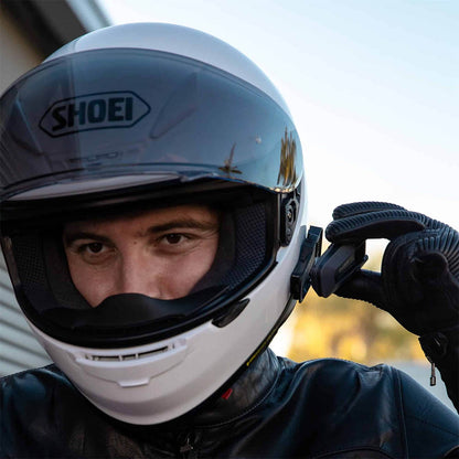 Motorcyclist wearing a helmet with installed Cardo intercom system