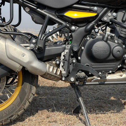 Matte black master cylinder guard installed on motorcycle, protective bracket visible