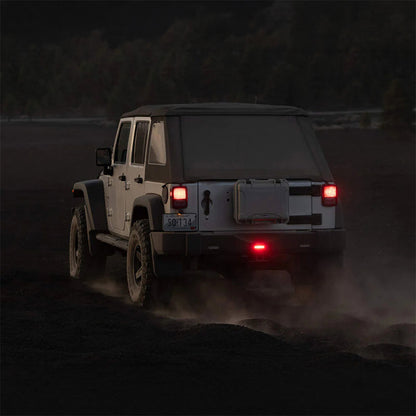 Red LED brake lights on the rear of a vehicle, with central lamp lit