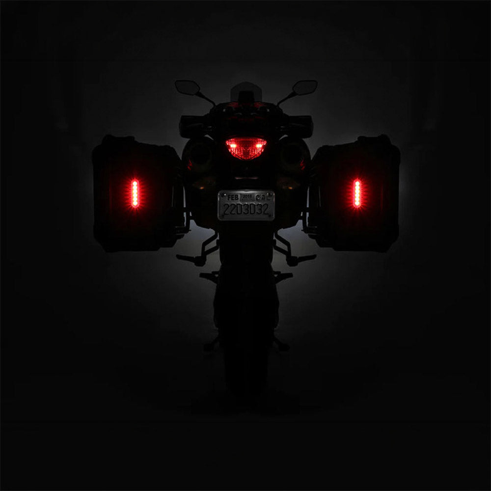 Red LED brake light and turn signals glowing on the motorcycle rear