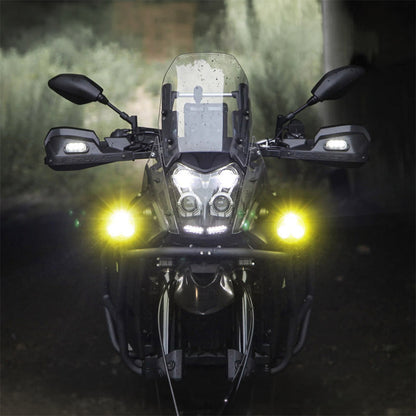 Black auxiliary LED light pods lighting up the road ahead on a motorcycle