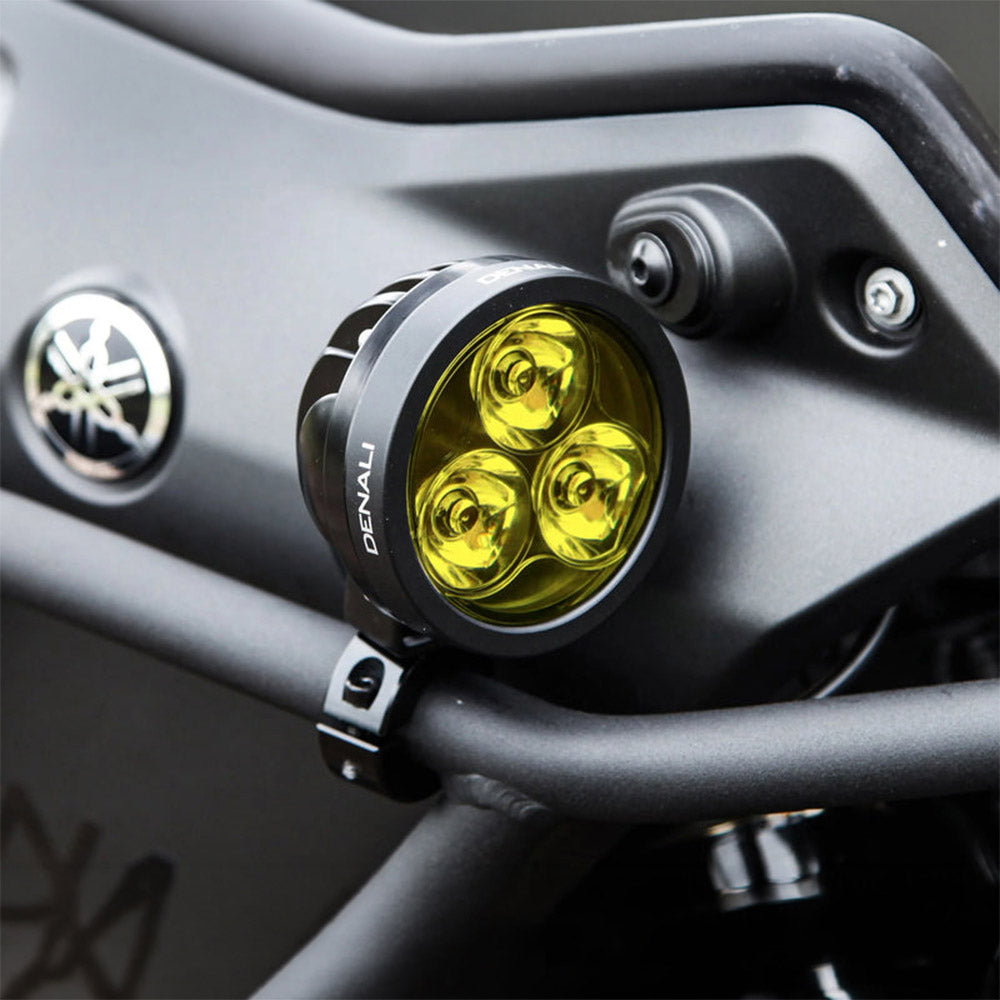 Black Denali D3 LED light pod with three lenses lit in bright yellow