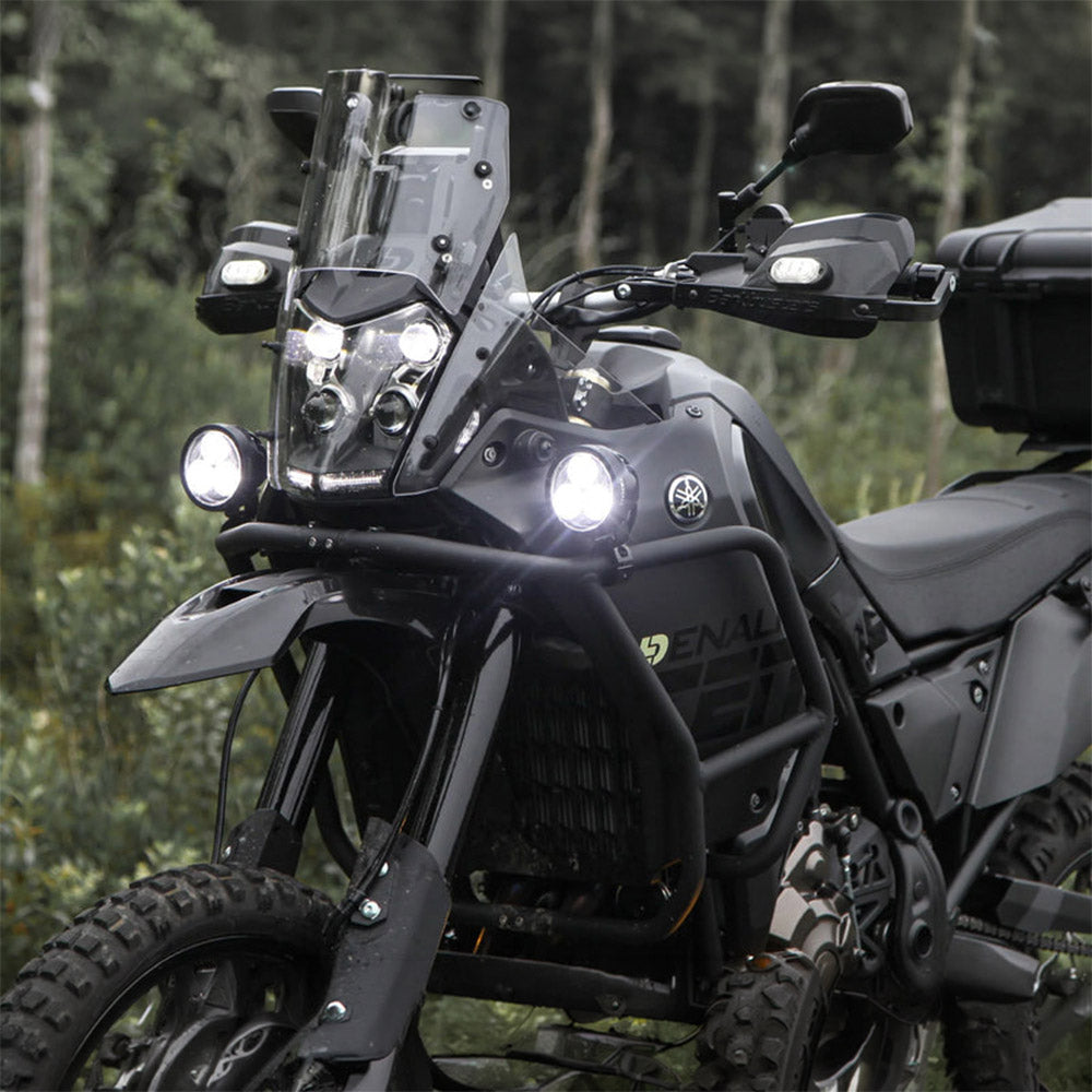 Black auxiliary LED light pods mounted on motorcycle front, small lights in close view