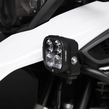 Black driving light pod close-up with clear multi-lens housing and mounting bolt