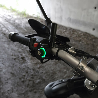 Black DialDim controller with green-lit dial ring on motorcycle handlebar