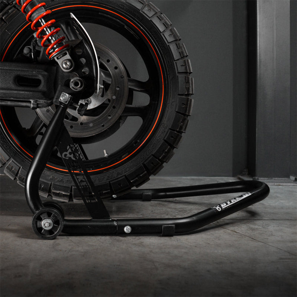 Black paddock stand supporting rear wheel area with caster base and arm