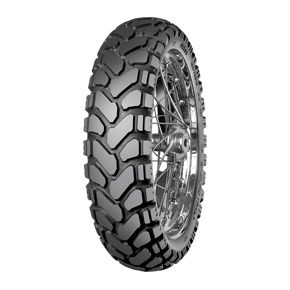 Rear tubeless tyre with aggressive off-road tread and silver rim, dark rubber