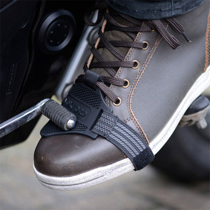 Black shoe protector toe guard strap with textured grip, secured on lace-up shoe