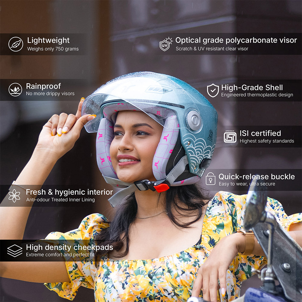 Aqua blue full-face motorcycle helmet on a woman, open visor and pink lining