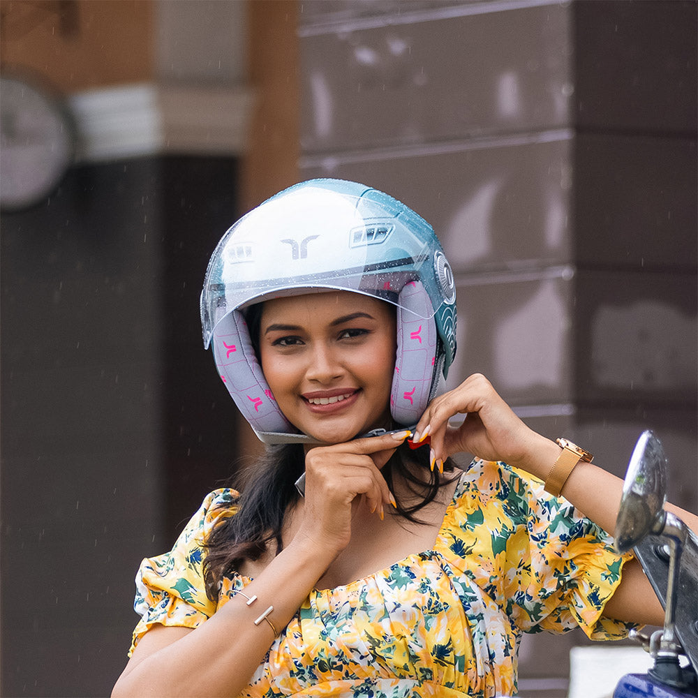 Aqua blue helmet worn by a woman with visor down and wave pattern on sides