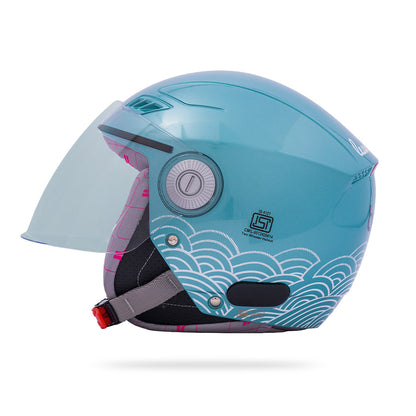 Motorcycle riding helmet in aqua blue with clear visor and wave graphic front