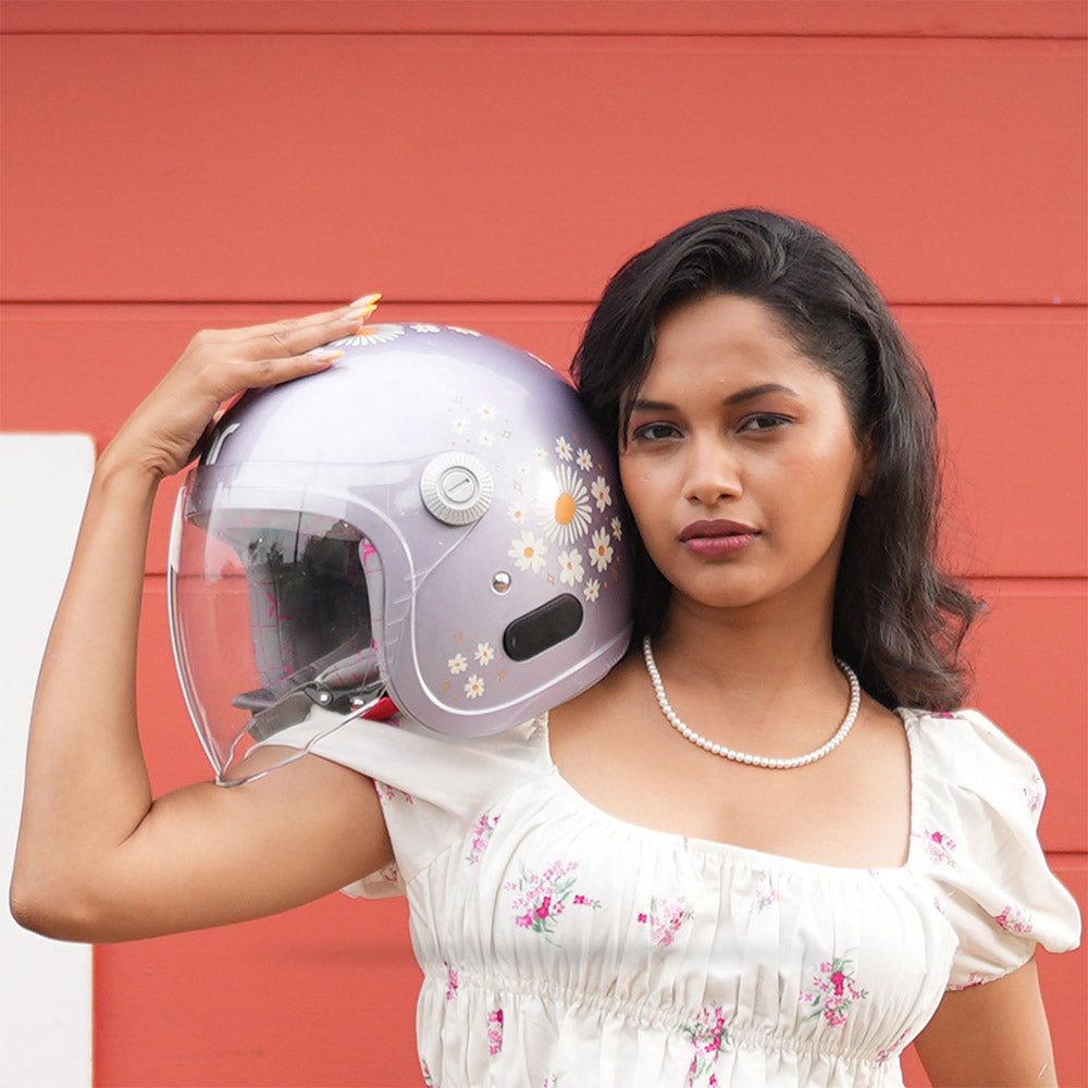 Lilac motorcycle helmet with clear visor and daisy flower pattern