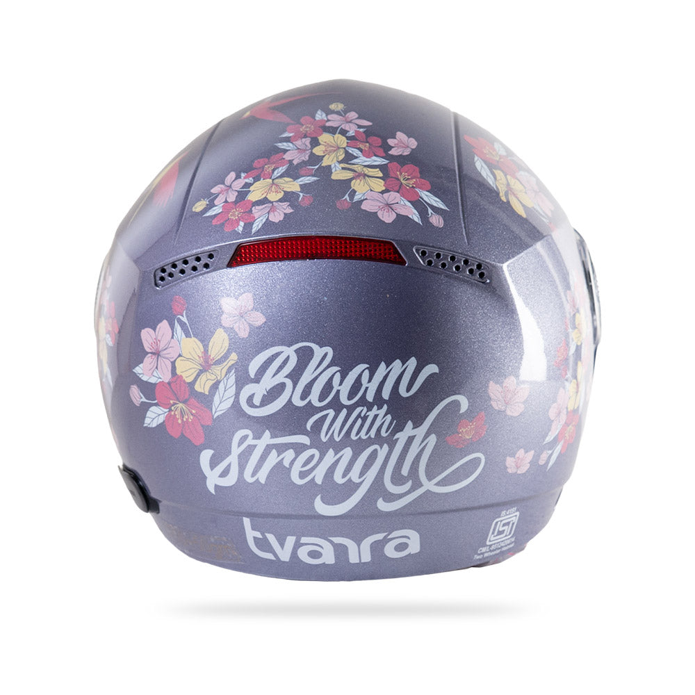 Motorcycle riding helmet in dark lilac with floral graphic; clear visor and vent detail