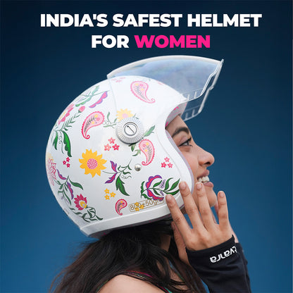 Women’s motorcycle helmet with colorful floral print and clear face visor, hand touching helmet